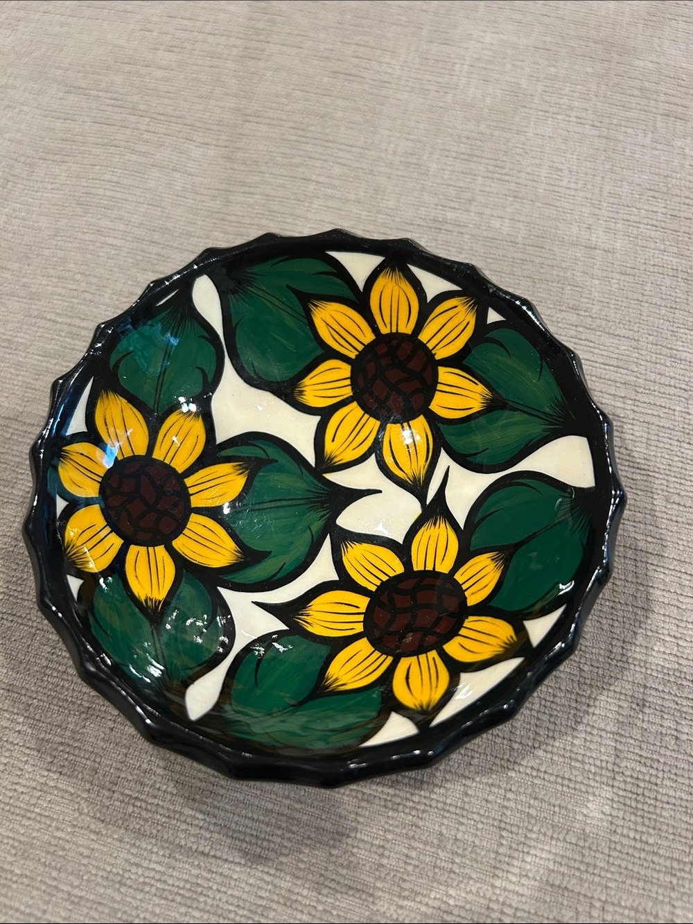 Hand-painted Mexican ceramic bowl/plate with a scalloped black rim & sunflowers